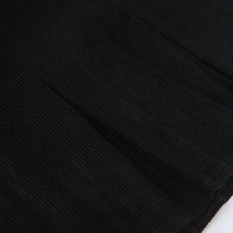 Minifalda plisada de talle alto de pana negra